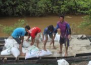 Satgas TMMD dan Warga Angkut Material dalam Karung ke Lokasi Pengecoran Jalan